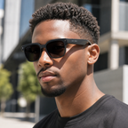 DriveNova AI glasses worn outdoors with darkened photochromic lenses